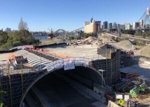 Tunnel construction at Rozelle Interchnage in Sydney with Sydney harbour inthe background: Geoquest Supports Transformation in Sydney’s Transportation Landscape