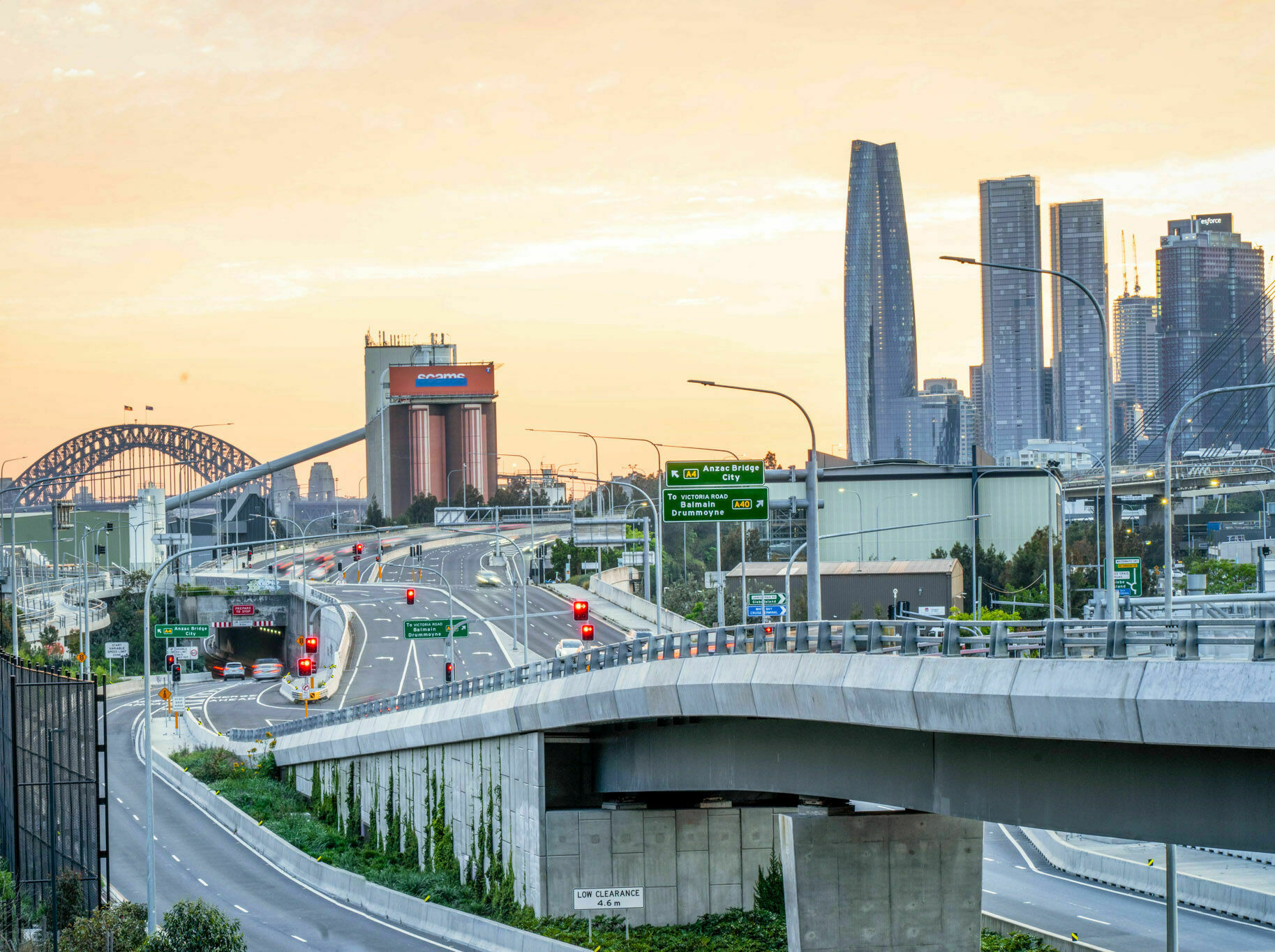 WestConnex Rozelle Interchange at sunset with Sydney Harbour Bridge behind it