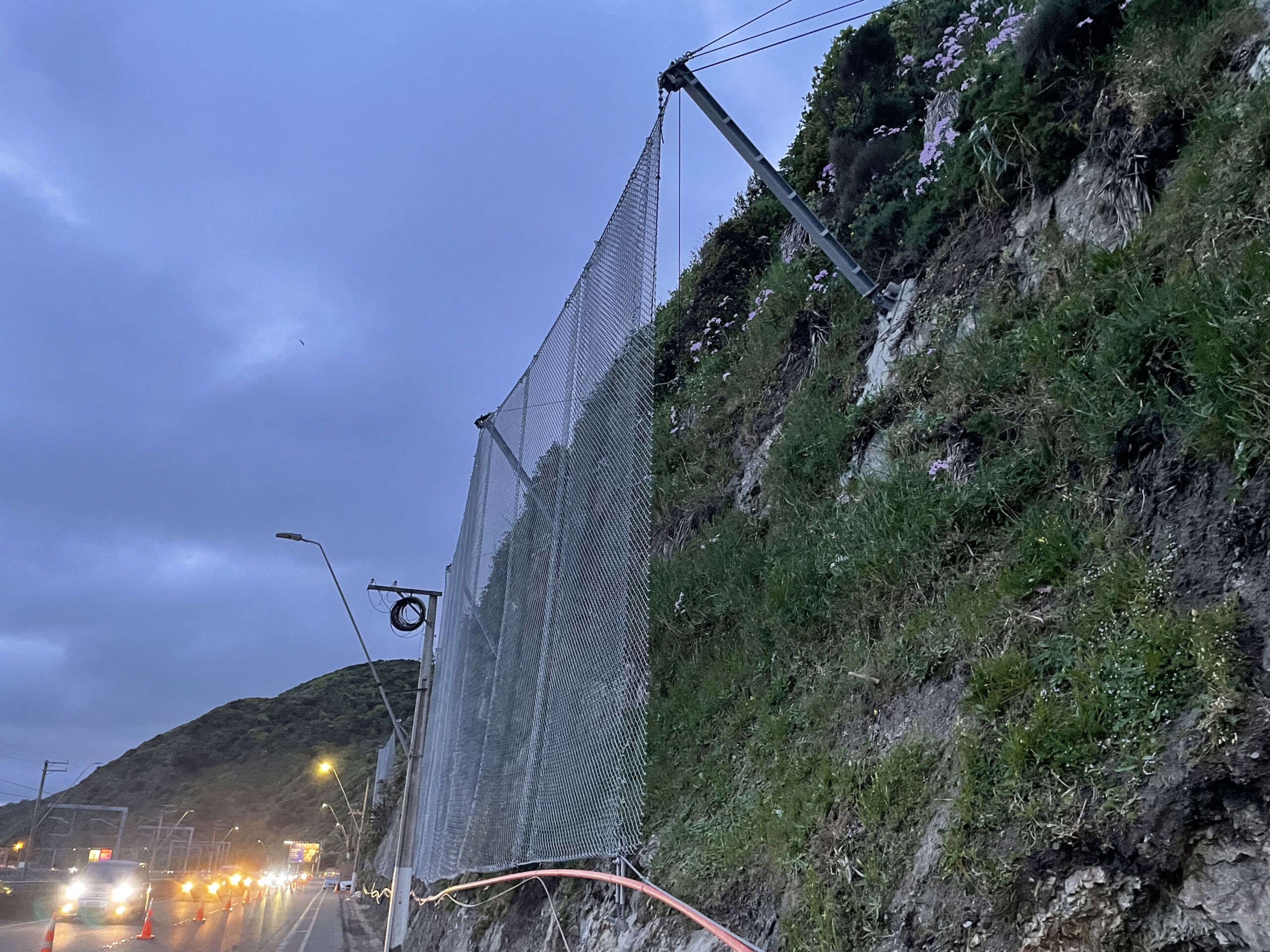 Rockfall protection barrier fence installed on a rockface alongside a New Zealand highway
