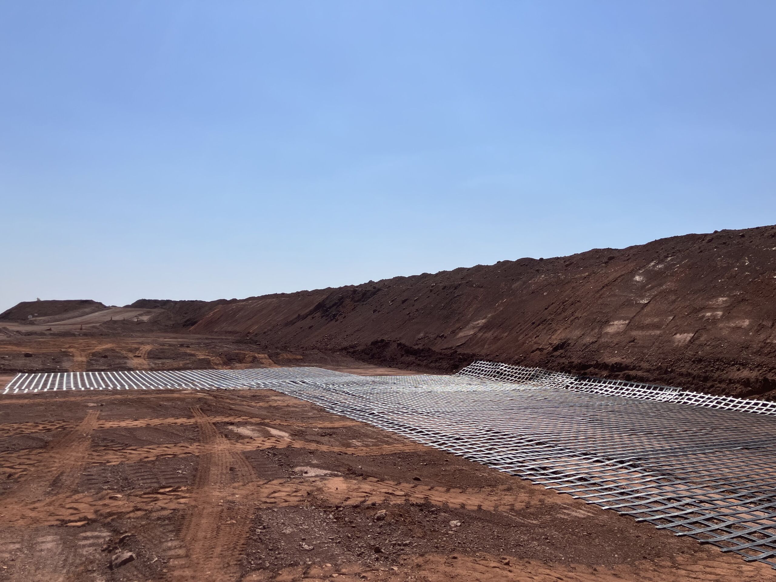 Iron ore mine site in WA’s Pilbara ground reinforcement geosynthetic ArmaLynk Pilbara mine site geosynthetics ground reinforcement, ArmaLynk by Geoquest being installed.