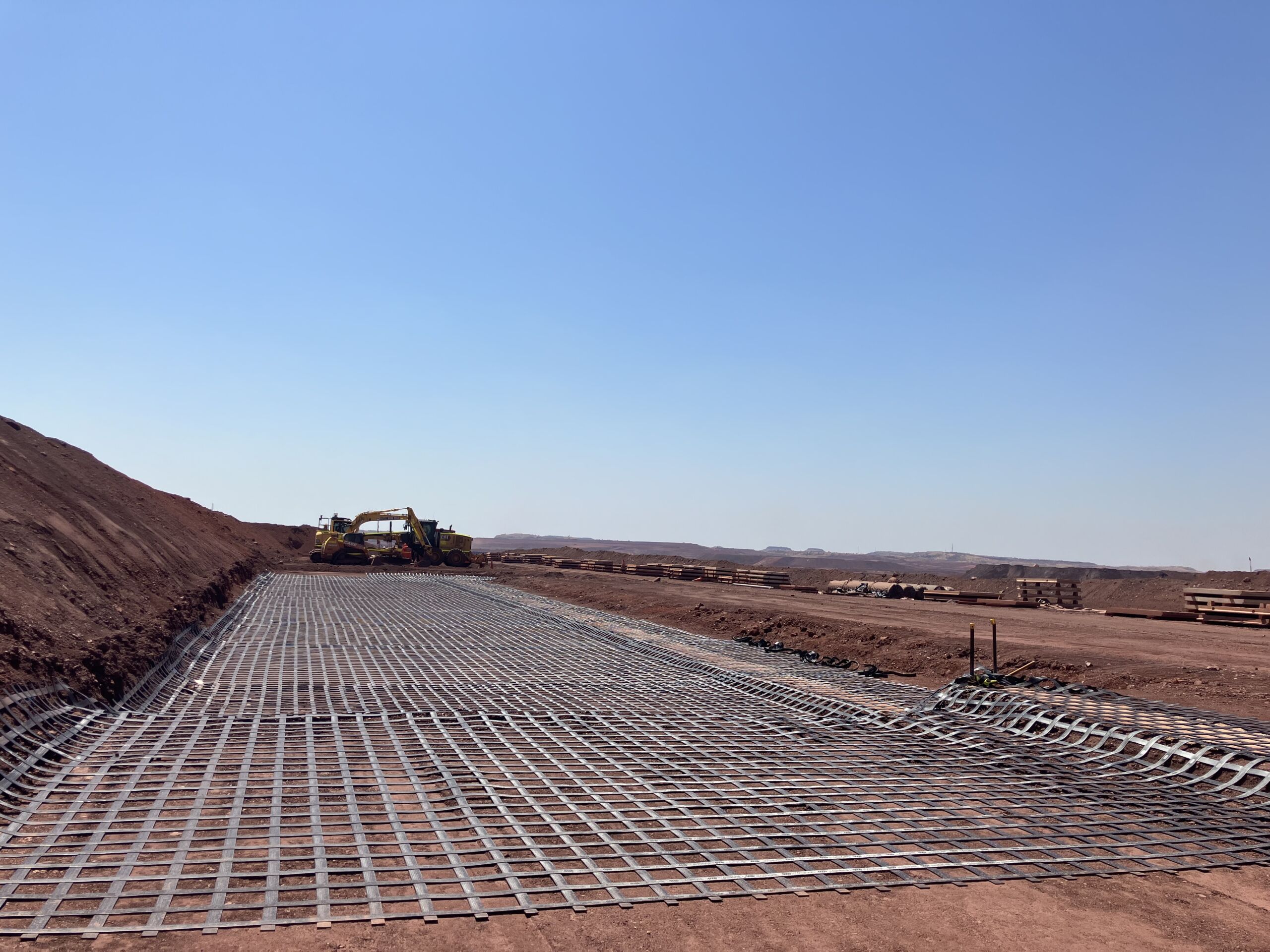 Roy Hill Mine site Pilbara geosynthetics ground reinforcement Pilbara mine site geosynthetics ground reinforcement, ArmaLynk by Geoquest being installed.